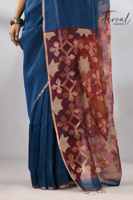 Blue handwoven Jamdani saree featuring a maroon star pallu bottom