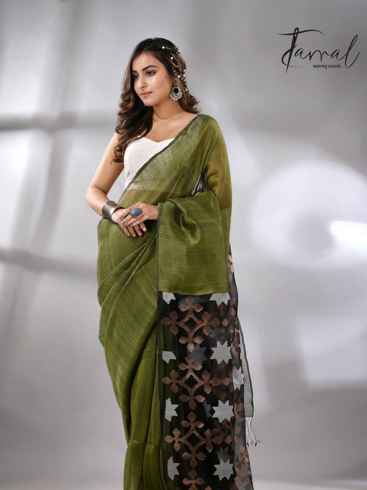 Linen handwoven jamdani saree in green and black star pallu