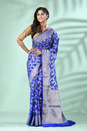 Royal Blue Banarasi Silk Saree with Antique Silver Zari Jal Weave, styled elegantly on a model against a soft green backgroun